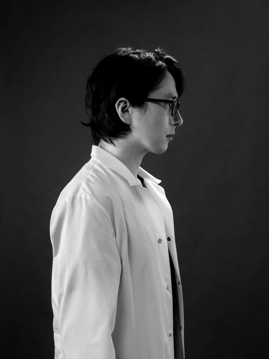 Editorial side profile portrait of Dr. Elias Laurent